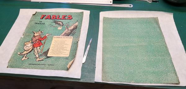 Les pages de couverture demandent un traitement particulier car il est nécessaire de doubler les deux pages de la couverture sur le verso, avec un papier japon plus épais. On laisse dépasser le papier japon de trois centimètres. Cet onglet sera plié et permettra d’assembler la couverture au premier et dernier cahier. 